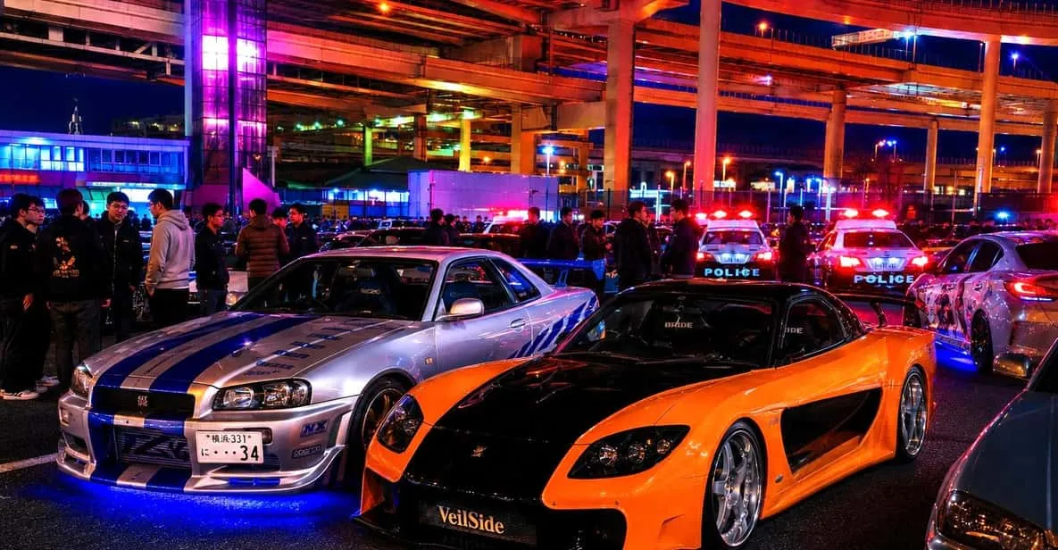 Sports cars crossing the Rainbow Bridge at night on a daikoku pa tour in Tokyo