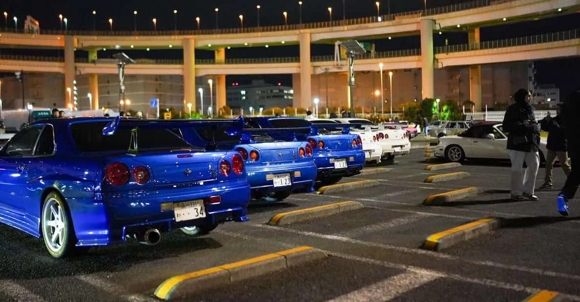 Modified Nissan GT-R R34 at the Daikoku PA meet at night on a daikoku pa tour in Tokyo